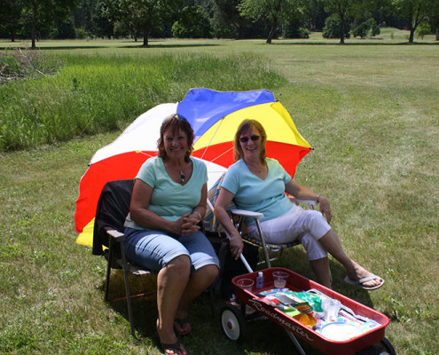 Mary Cheney and Judy Lovse -Watching for a Hole-in-One. A hole-in-one at hole #8 would ensure the winning of a Yamaha Side by Side, 4-Wheeler valued at $14,000 donated by Boundary Tractor Co.