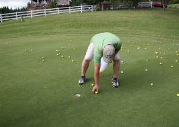 Brent Dehlbom, member of Fry Healthcare Foundation Board of Directors picks up the winning golf ball.