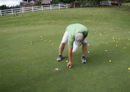 Brent Dehlbom, member of Fry Healthcare Foundation Board of Directors picks up the winning golf ball.