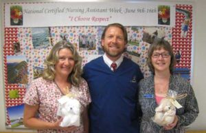 Wanda Wilkerson (left) and Sean McCoy (center) from the hospital Emergency Department accept the stuffed critters from Fry Healthcare Foundation President, Carol Julian (right).